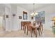 Dining room features a wooden table set, chandelier lighting, and a window providing natural light at 11103 Batello Dr, Venice, FL 34292