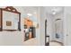 Open hallway view to kitchen and front door featuring neutral color scheme at 11103 Batello Dr, Venice, FL 34292