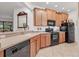 Modern kitchen with wood cabinets and black appliances at 11103 Batello Dr, Venice, FL 34292