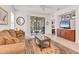 Cozy living room featuring tile flooring and open slider to patio at 11103 Batello Dr, Venice, FL 34292
