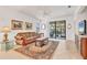 Comfortable living room with neutral tones, tile floors and bright lighting at 11103 Batello Dr, Venice, FL 34292
