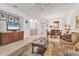 Bright living room with tile flooring, ceiling fan, and open layout to dining area at 11103 Batello Dr, Venice, FL 34292