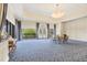 Bright, sunlit meeting room with floor-to-ceiling windows and a comfortable seating arrangement at 11103 Batello Dr, Venice, FL 34292