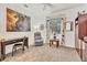 Office space featuring a desk, comfortable chair, and a large window with decorative curtains at 11103 Batello Dr, Venice, FL 34292