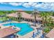 Aerial view of community pool with palm trees and multiple seating areas at 11103 Batello Dr, Venice, FL 34292