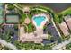 An aerial view showcases the pool and clubhouse, tennis courts, and a basketball court at 11624 Garessio Ln, Sarasota, FL 34238