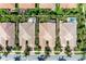 An overhead view of multiple homes featuring tile roofs, lush landscaping, and screened-in patios at 11624 Garessio Ln, Sarasota, FL 34238