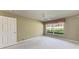 Bright bedroom with neutral paint, carpet, ceiling fan, and a large window at 11624 Garessio Ln, Sarasota, FL 34238