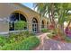 Exterior of building with beautiful landscaping, stone accents, and arched windows at 11624 Garessio Ln, Sarasota, FL 34238