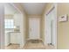 Foyer with tile flooring, coat closet, laundry room and access to the garage at 11624 Garessio Ln, Sarasota, FL 34238