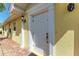 Classic white front door with sidelight and exterior light fixture at 11624 Garessio Ln, Sarasota, FL 34238