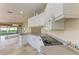 Bright kitchen features white cabinetry, granite countertops and stainless steel appliances at 11624 Garessio Ln, Sarasota, FL 34238