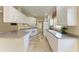 Clean kitchen with granite countertops and an abundance of white cabinetry at 11624 Garessio Ln, Sarasota, FL 34238