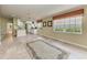Open concept living room with tile floors, neutral paint and lots of natural light at 11624 Garessio Ln, Sarasota, FL 34238