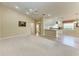 The open living space showcases neutral decor, a ceiling fan, and easy access to the kitchen at 11624 Garessio Ln, Sarasota, FL 34238