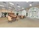 Bright lounge area with a high ceiling, lots of seating, beautiful windows, and natural light at 11624 Garessio Ln, Sarasota, FL 34238