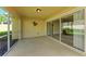 A screened patio with tile flooring, and sliding glass doors overlooking the home's interior at 11624 Garessio Ln, Sarasota, FL 34238