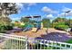 A well-maintained community playground area with slides, climbing wall, and swings at 11624 Garessio Ln, Sarasota, FL 34238