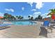 Community pool with plenty of seating and tropical landscaping at 11624 Garessio Ln, Sarasota, FL 34238