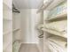 A well-organized walk-in closet with shelving and ample storage space at 11624 Garessio Ln, Sarasota, FL 34238