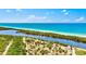 Expansive aerial view captures the lush shoreline, serene river, and tranquil waters, highlighting the property's scenic beauty at 11986 Granite Woods Loop, Venice, FL 34292