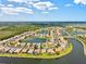 Expansive aerial view of a residential area boasting multiple lakes, tree coverage, and winding roads at 11986 Granite Woods Loop, Venice, FL 34292