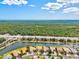 Beautiful aerial view of a home and neighborhood by a highway, canal, and lush greenery at 11986 Granite Woods Loop, Venice, FL 34292