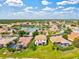 Scenic aerial view of a community with a beautiful lake, lush trees, and manicured lawns at 11986 Granite Woods Loop, Venice, FL 34292