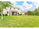 Expansive backyard with lush green grass and a view of the home's exterior at 11986 Granite Woods Loop, Venice, FL 34292