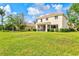 Beautiful backyard with a well-manicured lawn and a screened-in patio for outdoor relaxation at 11986 Granite Woods Loop, Venice, FL 34292