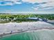 Scenic beachfront property featuring white sands, clear waters, and lush greenery, providing a serene and luxurious coastal lifestyle at 11986 Granite Woods Loop, Venice, FL 34292