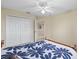 Bedroom with a bright window, ceiling fan, and closet at 11986 Granite Woods Loop, Venice, FL 34292