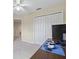 Cozy carpeted bedroom with white closet doors and a modern ceiling fan at 11986 Granite Woods Loop, Venice, FL 34292