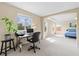 Spacious bedroom with a desk and computer setup, plus an arched entry to sleeping area at 11986 Granite Woods Loop, Venice, FL 34292