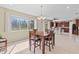 An eat in kitchen flows into the dinning room with a view to outside at 11986 Granite Woods Loop, Venice, FL 34292