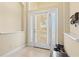 Bright foyer with neutral walls, tile flooring, and a view of the front door with glass sidelights at 11986 Granite Woods Loop, Venice, FL 34292