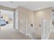 Second floor hallway with plush carpet and neutral paint leads to bedrooms at 11986 Granite Woods Loop, Venice, FL 34292