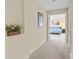 Second floor hallway with plush carpet leads to bedroom with ceiling fan at 11986 Granite Woods Loop, Venice, FL 34292
