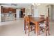 Spacious eat-in kitchen boasts stainless appliances, wooden cabinetry, and modern lighting fixture at 11986 Granite Woods Loop, Venice, FL 34292