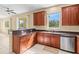 Kitchen with stainless steel appliances and an eat-in bar that flows into the dining area at 11986 Granite Woods Loop, Venice, FL 34292