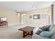 Spacious living room with neutral walls, plush carpet, and comfortable seating at 11986 Granite Woods Loop, Venice, FL 34292