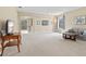Spacious living room with neutral walls, plush carpet, and a view to the backyard at 11986 Granite Woods Loop, Venice, FL 34292
