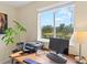 Bright office with a wood desk, modern computer and a lovely view of the outdoors at 11986 Granite Woods Loop, Venice, FL 34292