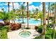 Beautiful pool area featuring lush landscaping, palm trees, and a relaxing spa at 11986 Granite Woods Loop, Venice, FL 34292