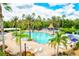 Expansive community pool area with ample lounge seating, shade structures, and tropical landscaping at 11986 Granite Woods Loop, Venice, FL 34292