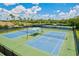 Tennis courts offering sun shelters, and well-maintained surfaces for an active lifestyle at 11986 Granite Woods Loop, Venice, FL 34292