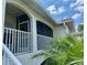 A screened-in balcony with an archway and white railings offers a shady spot to sit outside at 1204 L Pavia Blvd # 1204, Venice, FL 34292