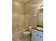Bathroom featuring tub with shower, commode, and granite-topped vanity at 1204 L Pavia Blvd # 1204, Venice, FL 34292