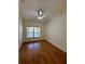 Bedroom features wood floors, a window, and ceiling fan at 1204 L Pavia Blvd # 1204, Venice, FL 34292