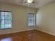 Bedroom featuring two windows, wood flooring and a ceiling fan at 1204 L Pavia Blvd # 1204, Venice, FL 34292